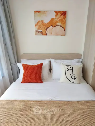 Cozy bedroom with stylish decor and modern art above bed