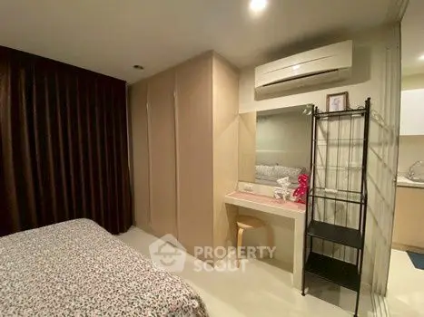 Cozy bedroom with built-in wardrobe and air conditioning unit