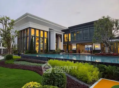 Luxurious modern villa with expansive pool and lush garden landscaping, perfect for upscale living.