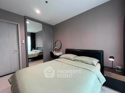 Modern bedroom with stylish decor and cozy ambiance, featuring a comfortable bed and elegant furnishings.