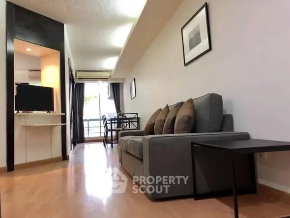 Modern living room with sleek furniture and natural light in a stylish apartment.