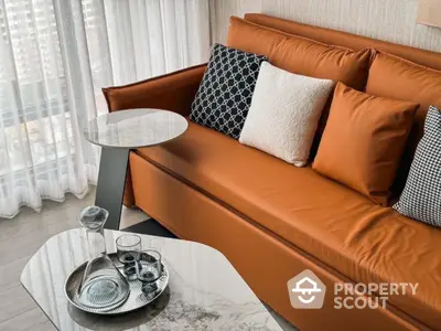 Modern living room with stylish orange sofa and elegant marble coffee table.