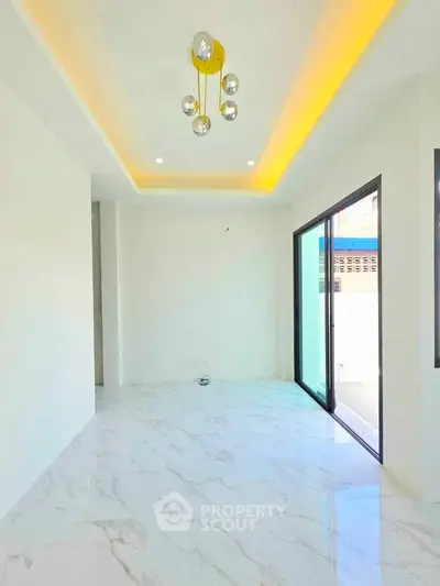 Modern living room with marble flooring and stylish lighting in a bright, open space.