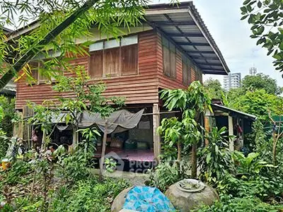 Charming rustic wooden house surrounded by lush greenery, offering a serene and natural living environment.