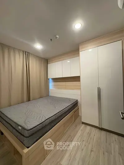 Modern bedroom with sleek built-in storage and cozy lighting