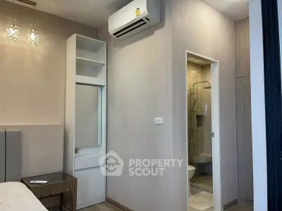 Modern bedroom with ensuite bathroom and air conditioning in stylish apartment
