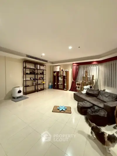 Spacious living room with modern furniture and elegant decor, perfect for relaxation and entertainment.