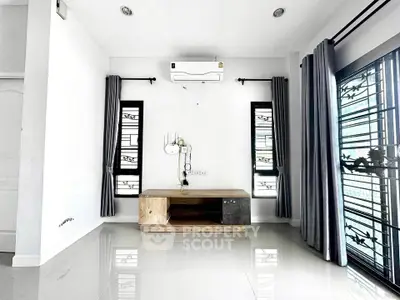 Modern minimalist living room with air conditioning and stylish window grills