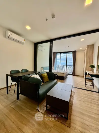 Modern living room with stylish furniture and large windows offering stunning city views.