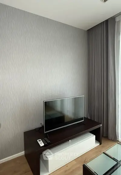 Modern living room with sleek TV setup and elegant curtains