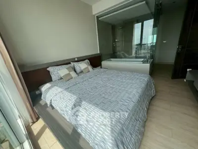 Luxurious bedroom with modern design and stunning city view, featuring a cozy bed and elegant decor.