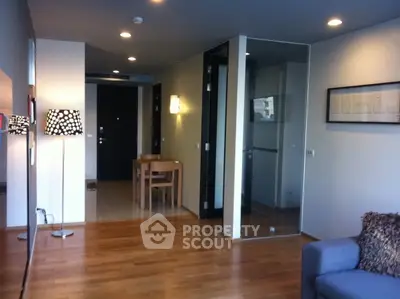 Modern living room with wooden flooring and stylish decor in a contemporary apartment.