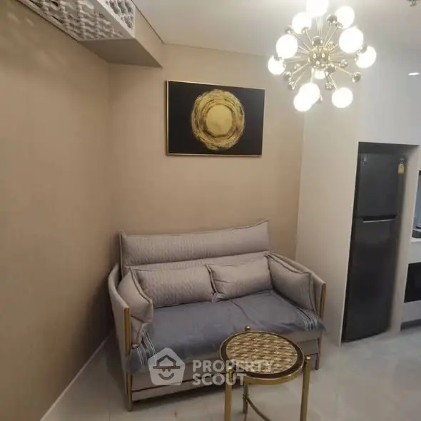 Cozy living room with modern chandelier and compact sofa