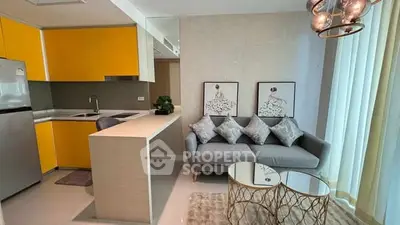 Modern living room with stylish decor and vibrant yellow kitchen cabinets