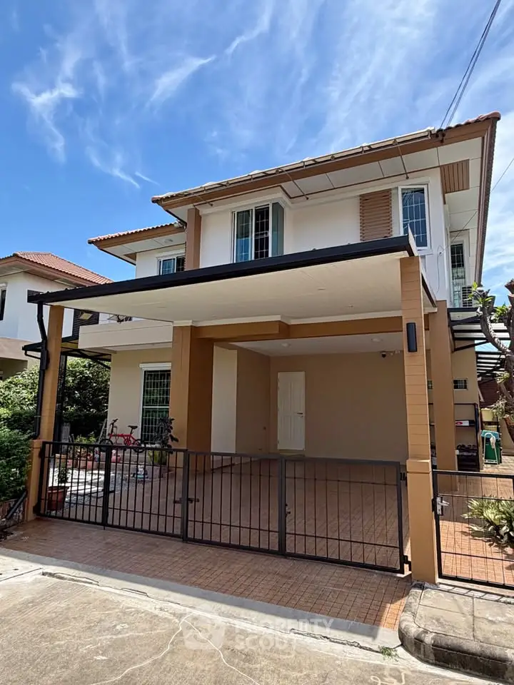Charming two-story house with a spacious carport and modern exterior design, perfect for family living.