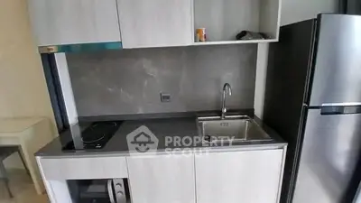 Modern compact kitchen with sleek cabinetry and stainless steel appliances