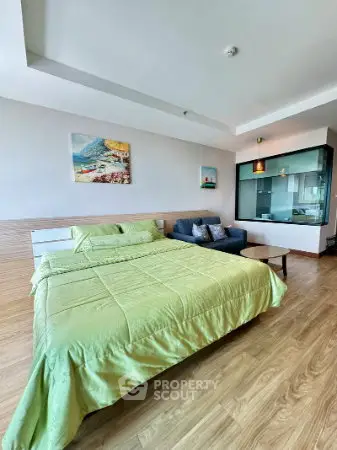 Spacious bedroom with modern decor and large window view