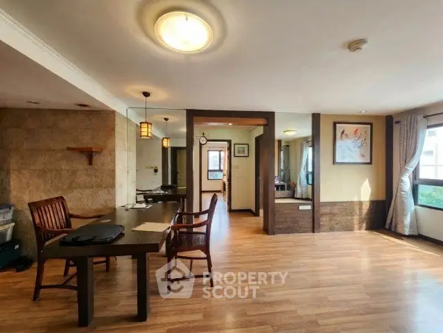 Spacious open-plan living area with wooden flooring and elegant decor