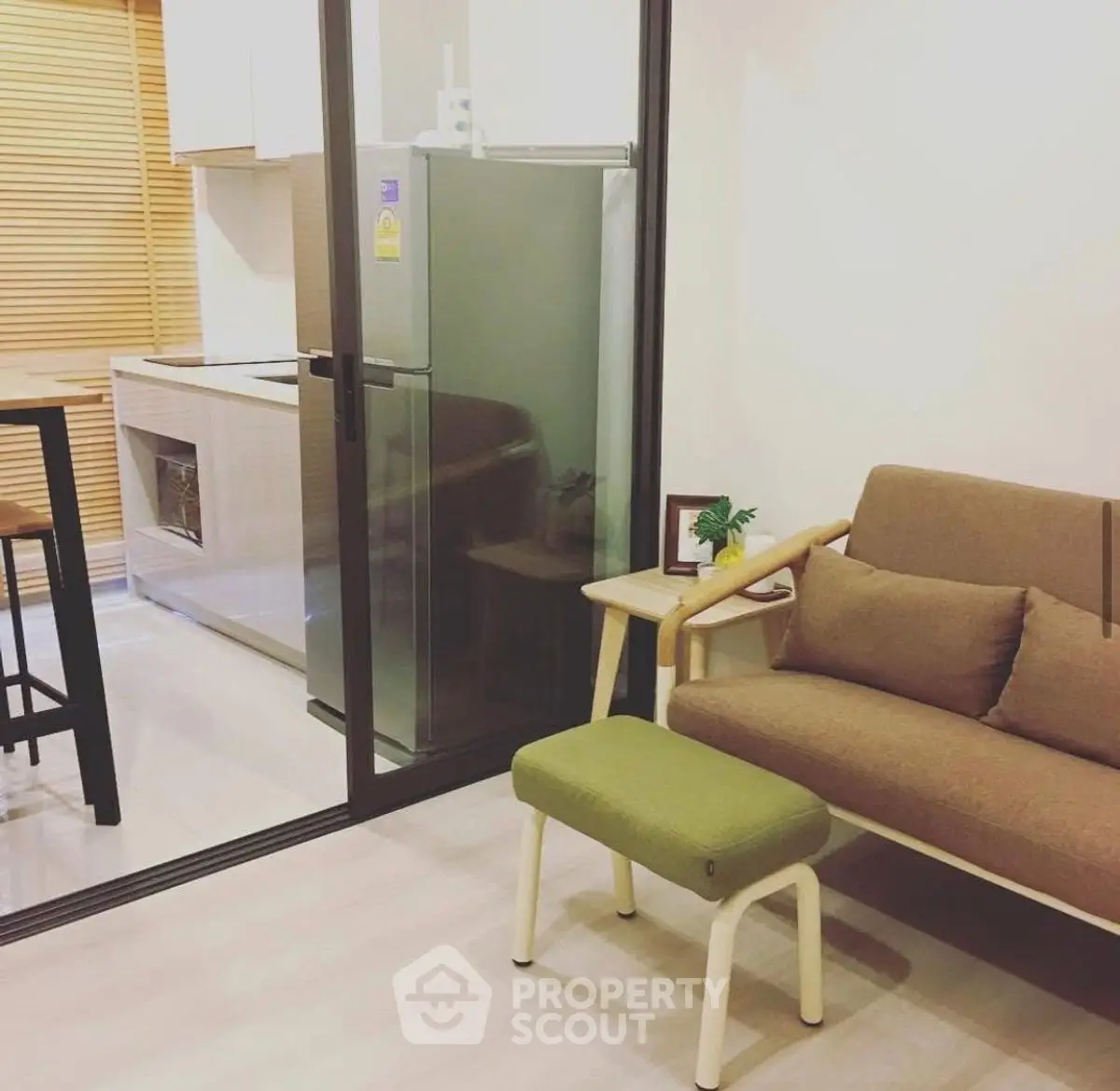 Modern apartment interior with cozy living area and compact kitchen.