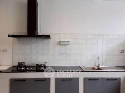 Modern kitchen with sleek cabinetry and gas stove, perfect for culinary enthusiasts.