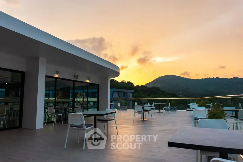 Stunning rooftop terrace with scenic mountain views at sunset, perfect for relaxation and gatherings.