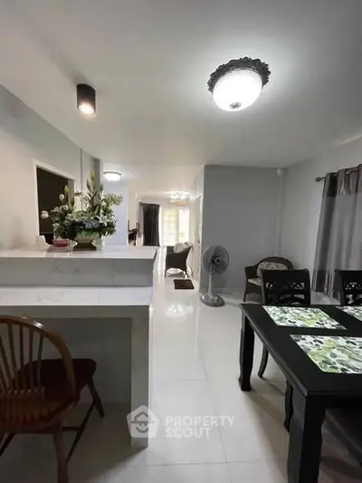 Spacious open-plan living and dining area with modern decor and ample natural light.