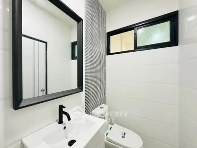 Modern bathroom with sleek black fixtures and stylish tile accents