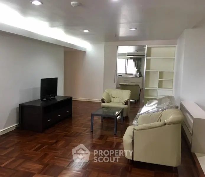 Spacious living room with elegant parquet flooring and modern furniture