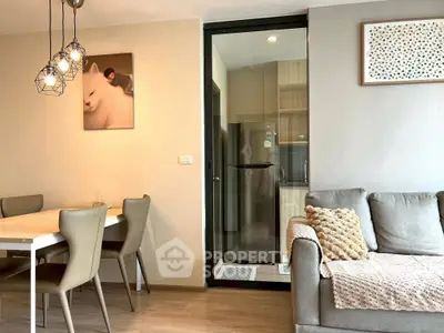 Modern living room with stylish dining area and cozy sofa, featuring elegant lighting and contemporary decor.