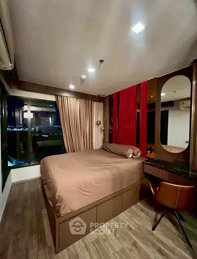 Luxurious bedroom with modern decor and city view, featuring elegant furnishings and ambient lighting.