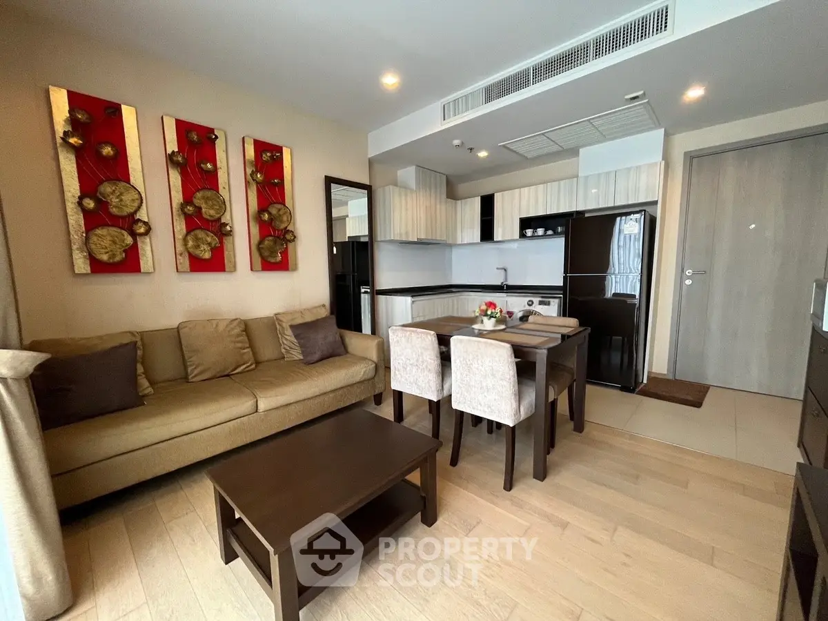 Modern living room with open kitchen layout and stylish decor