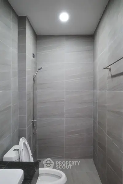 Modern bathroom with sleek gray tiles and minimalist design