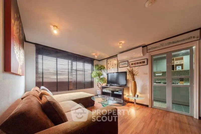 Spacious living room with modern decor and large windows in a stylish apartment.