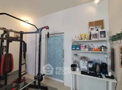 Modern home gym with exercise equipment and refreshment station