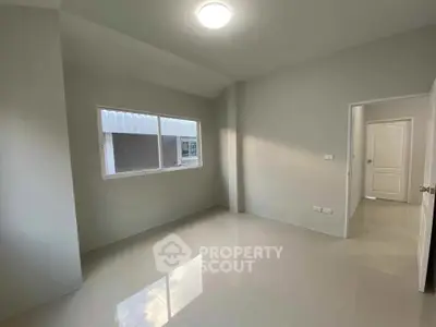 Spacious empty room with large window and glossy tiled floor, perfect for customization.