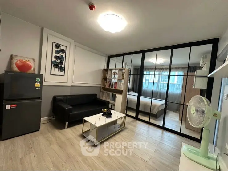 Modern living room with glass partition and sleek furniture