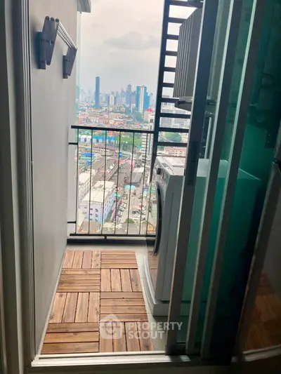 Charming balcony with city view and washing machine, perfect for urban living.