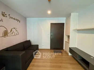 Modern living room with stylish black sofa and unique wall art, perfect for cozy relaxation.