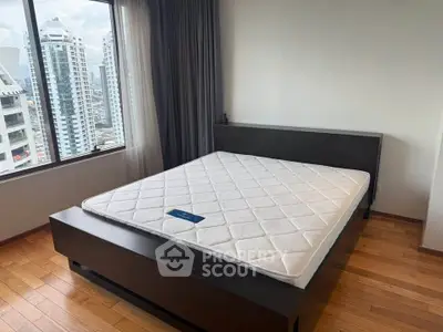 Spacious bedroom with city view and modern wooden flooring