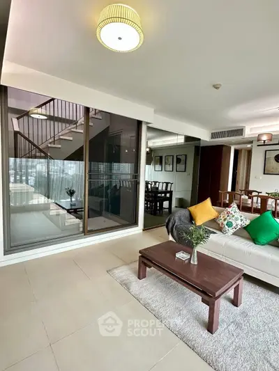 Spacious modern living room with elegant decor and large windows for natural light.