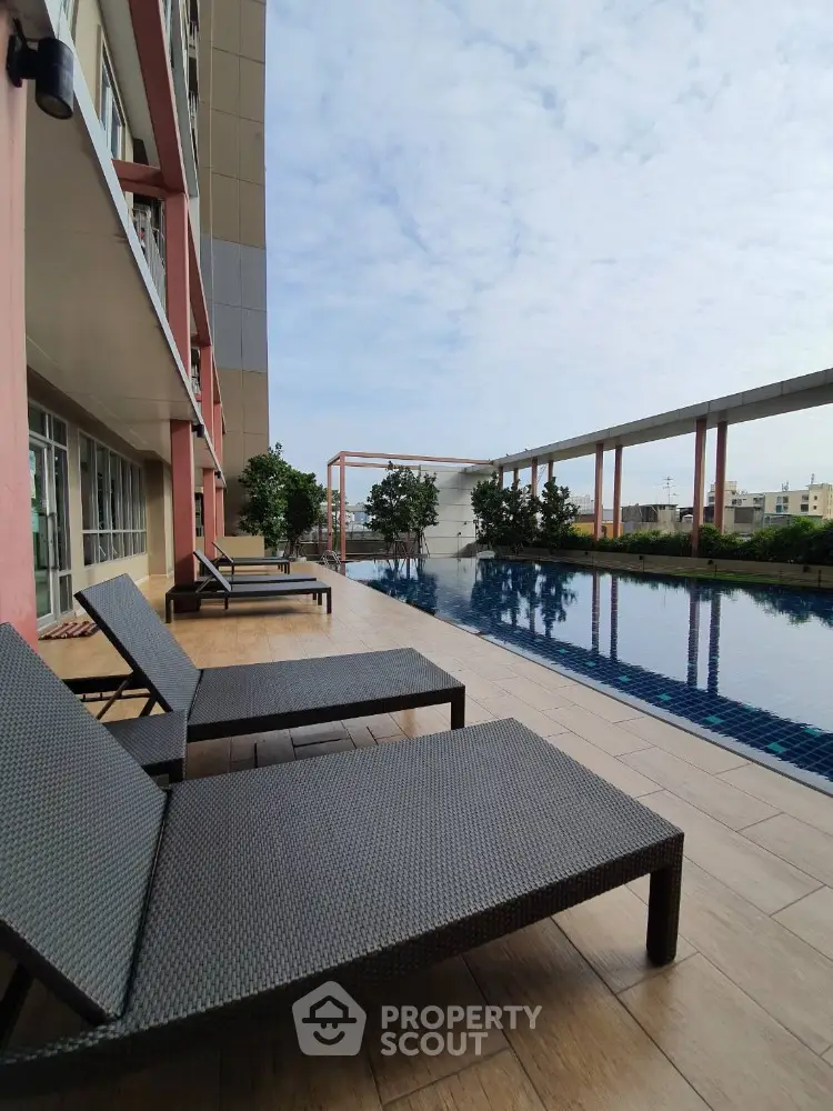 Luxurious rooftop pool area with modern sun loungers and stunning city views.