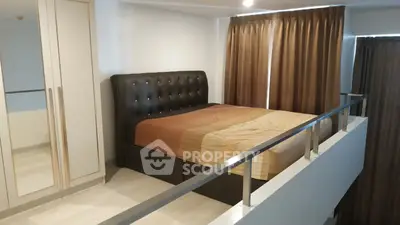 Modern loft bedroom with stylish bed and floor-to-ceiling curtains