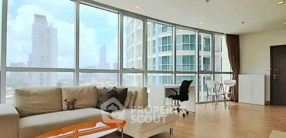 Spacious modern living room with panoramic city views and stylish furnishings.