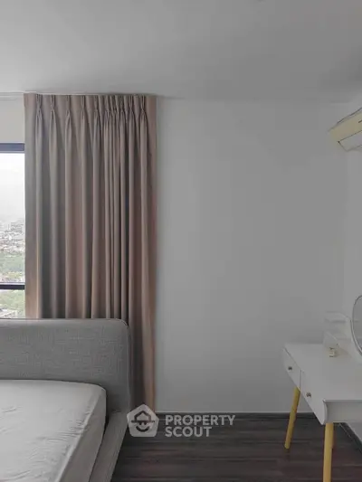 Modern bedroom with city view, featuring sleek furniture and neutral tones.