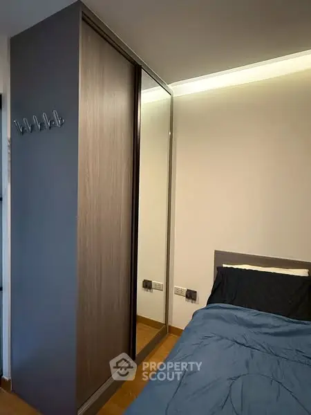 Modern bedroom with sleek wardrobe and cozy bedding