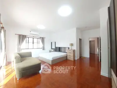 Spacious bedroom with modern furniture and natural light