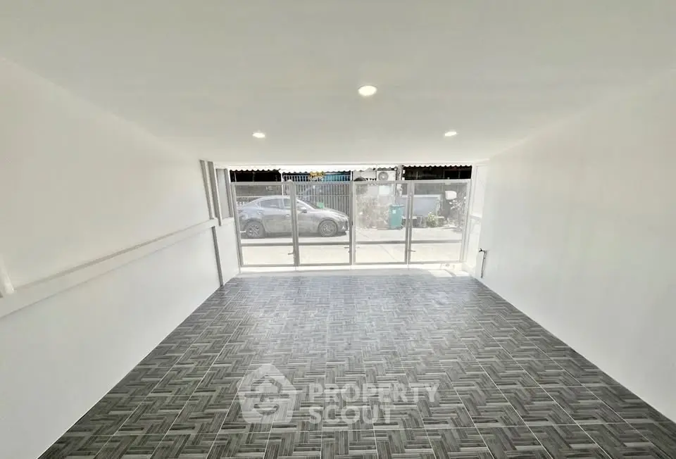 Spacious modern living room with large windows and stylish flooring