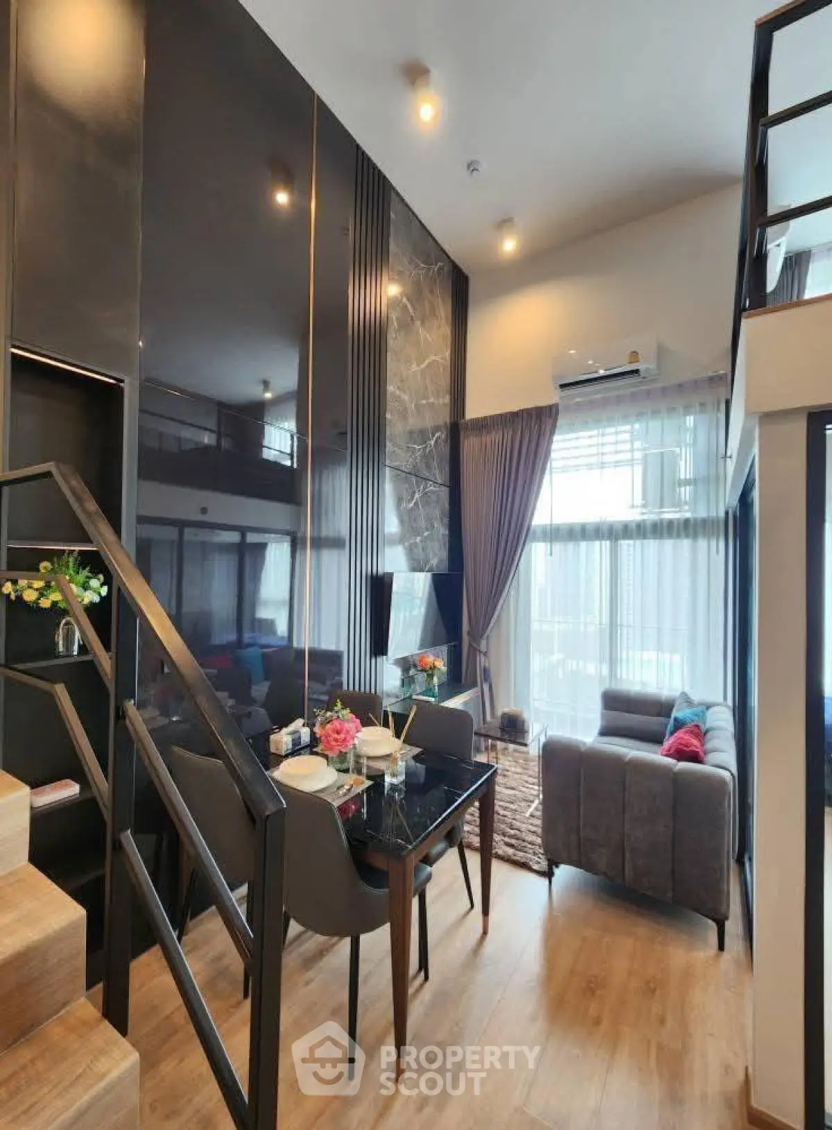 Modern duplex living room with high ceilings and stylish decor