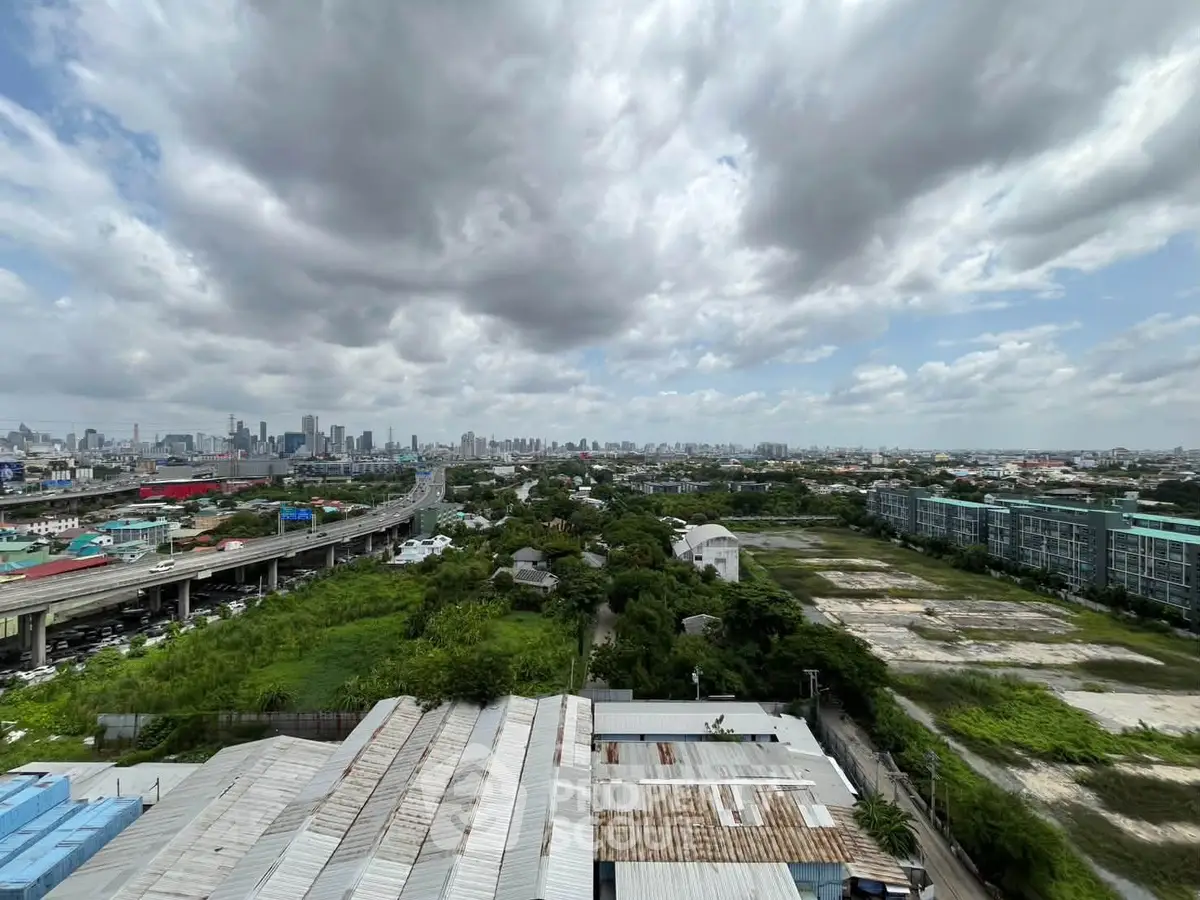 Stunning panoramic cityscape view from a high vantage point, showcasing urban skyline and lush greenery.