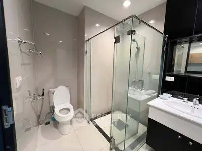 Modern bathroom with glass shower enclosure and sleek fixtures